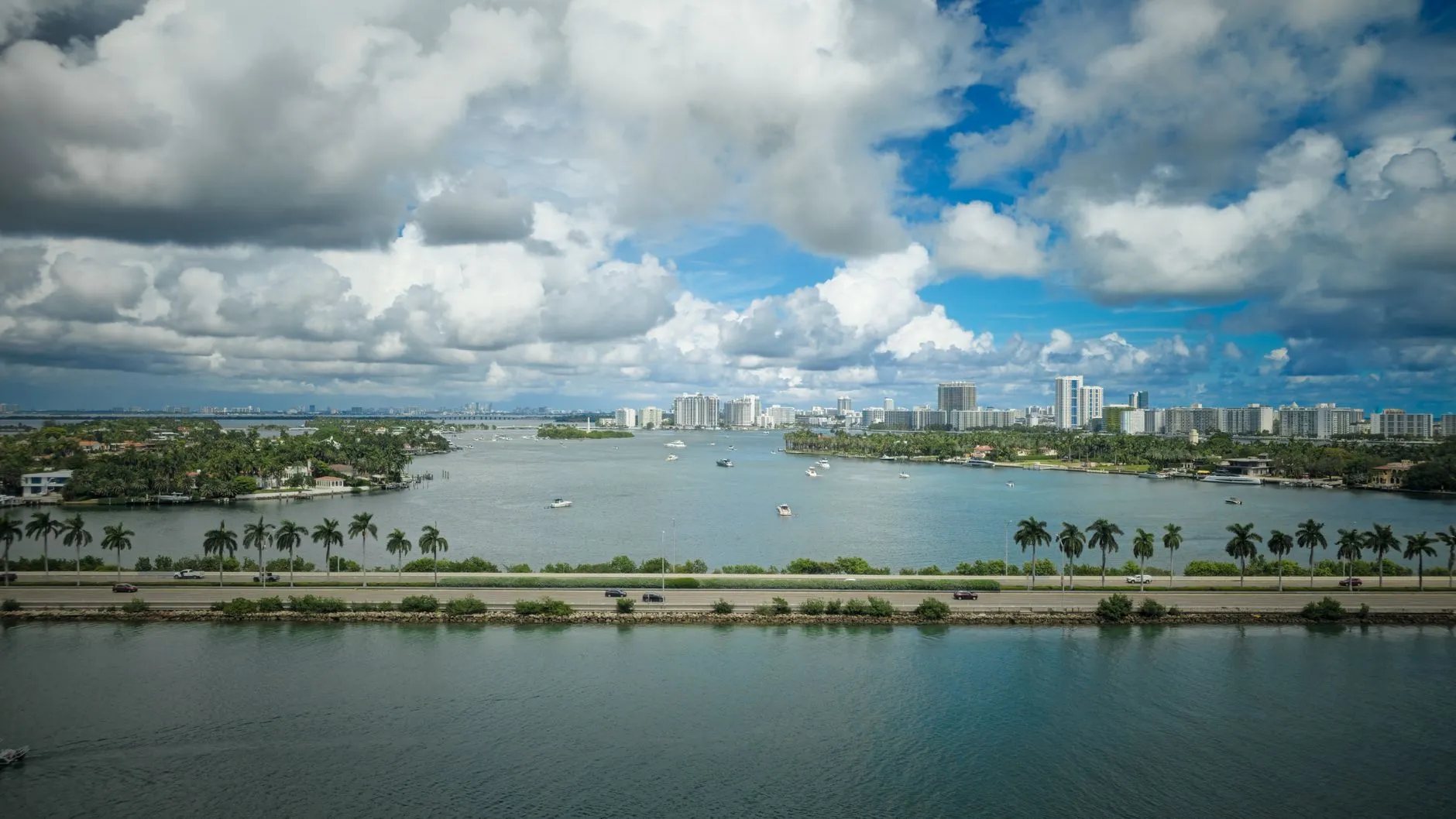 Biscayne Bay in Miami with a palm-lined causeway and waterfront towers